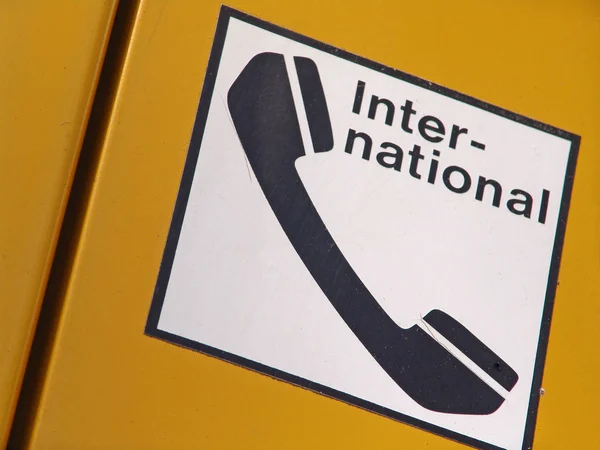 a yellow phone with a sign of emergency service