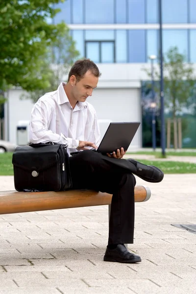 Young Businessman Sitting Bench Using Laptop Royalty Free Stock Photos