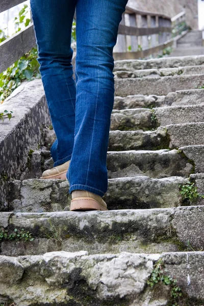 close up of a woman walking on the stairs