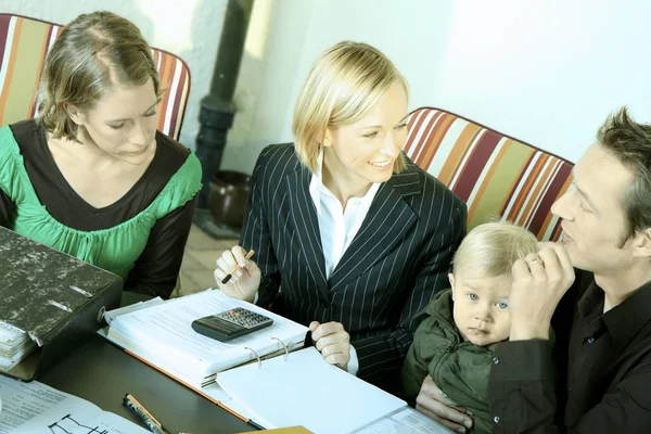 young family of four at work in the office