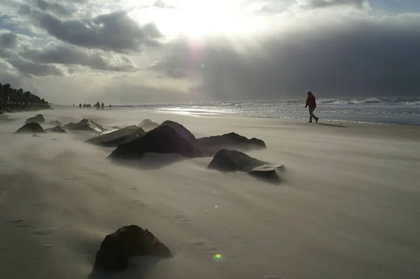 flying sand on the beach in front of westerland