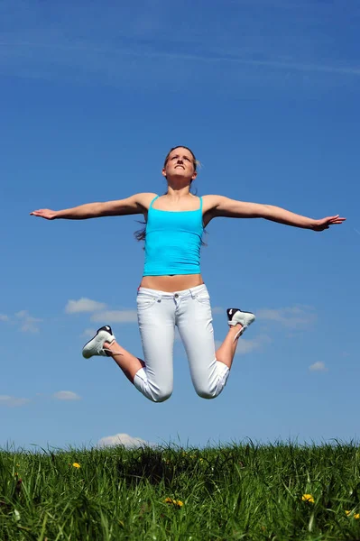 Young Woman Jumping Grass Stock Photo