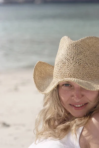 ビーチで帽子をかぶった若い女性が — ストック写真
