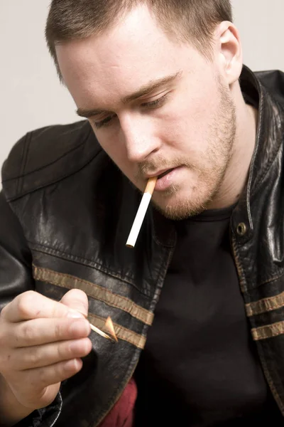 man smoking a cigarette
