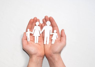 family holding paper in hands on blue background clipart