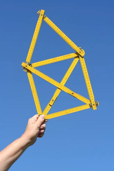 construction worker with hand holding a crane