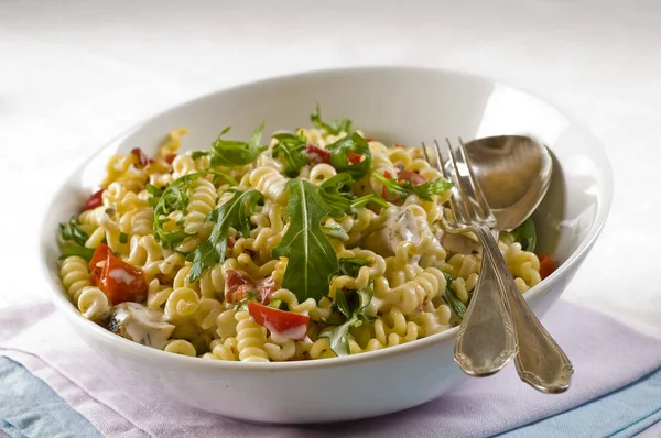 pasta salad with chicken breast,rocket and tomatoes