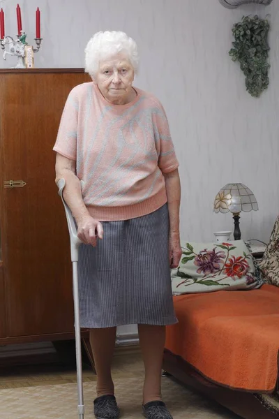 senior woman sitting on chair at home