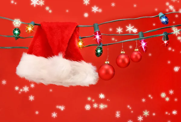 Hanging Lights Santa Hat Christmas Balls Red Background — Stock Photo, Image