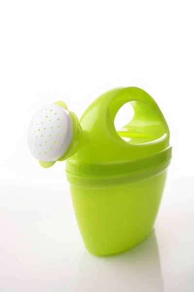 Green Toy Watering Can White Glossy Background Reflection — Stock Photo, Image