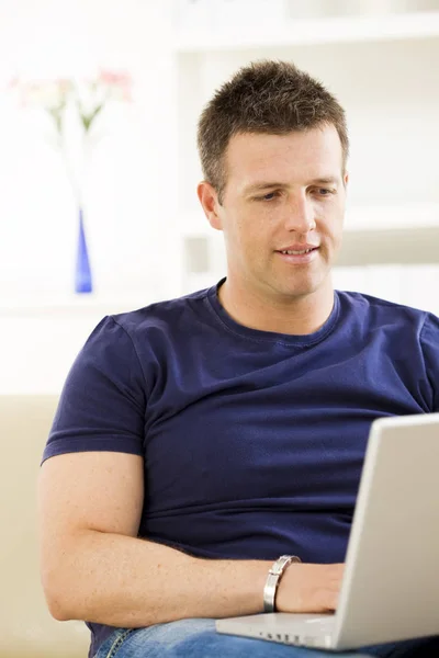 Man Sitting Sofa Home Using Laptop Computer Stock Image