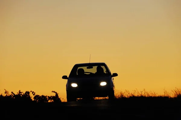 日没時の車のシルエットは — ストック写真