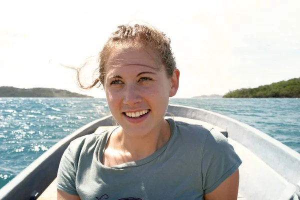 young woman in the boat is traveling on an island