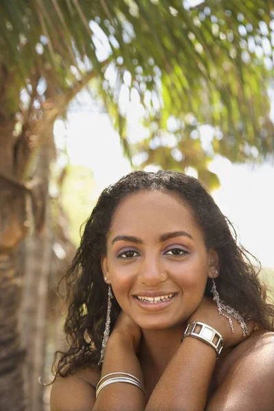 Young-adult African American female smiling and making eye contact.