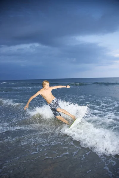 Caucasian Male Teen Riding Skimboard Royalty Free Stock Images