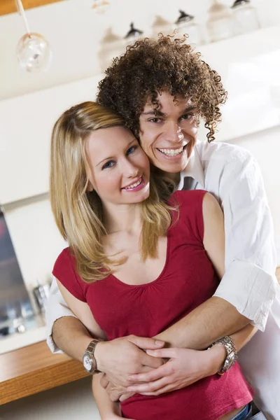 domestic life: happy interracial couple hugging