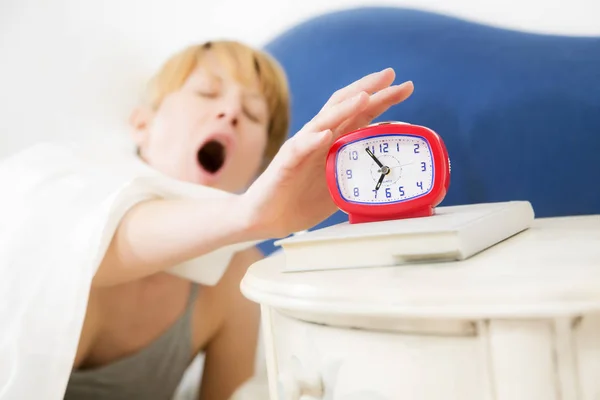 Young Woman Snoozing Red Alarm Clock — Stock Photo, Image