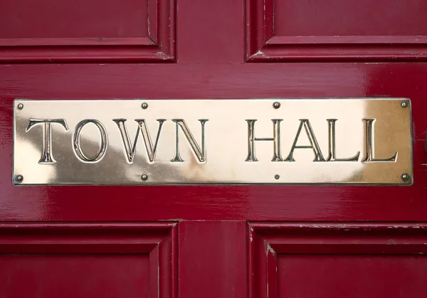 Brass Town Hall sign on a door.