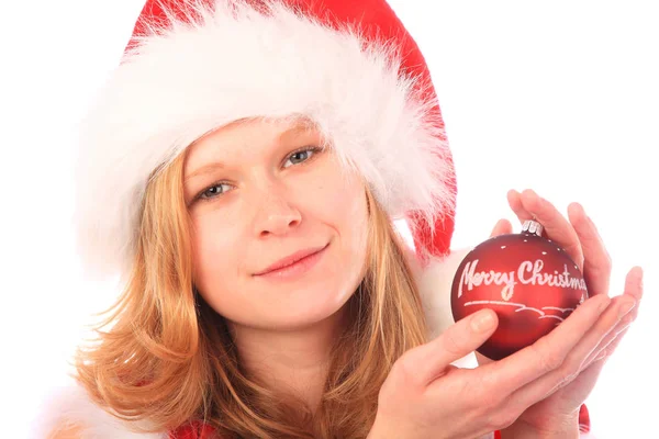 サンタさんは赤いクリスマスツリーボールを持っています ロイヤリティフリーのストック写真