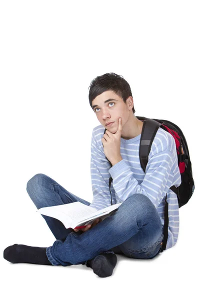 沉思的年轻男生坐在地板上看书 — 图库照片