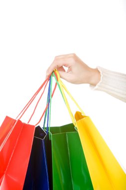 Woman hand carrying christmas shopping bags with gifts clipart