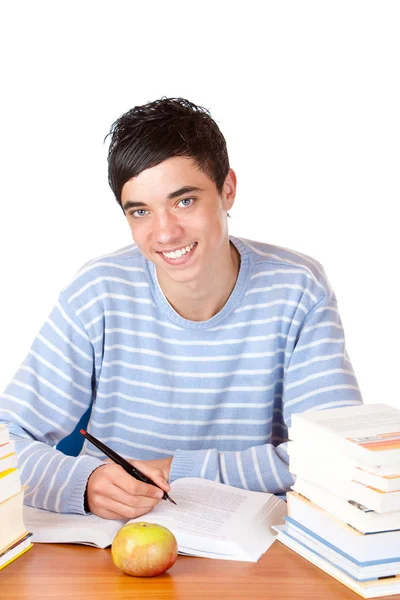年轻快乐英俊的男生坐在课桌前学习 — 图库照片