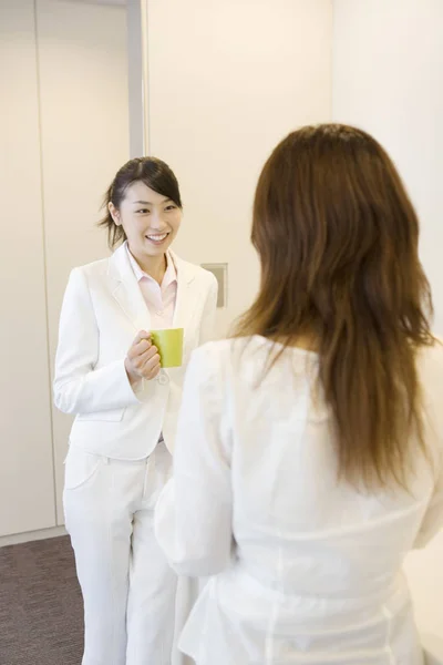 Office lady having a chat in an intermission