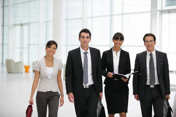 Men and women dressed in business suit walking in a modern society