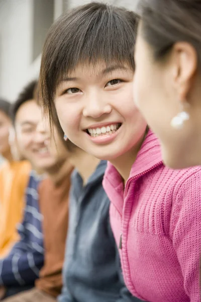 Young Woman Seated Group People Smiling Camera Vertically Framed Shot — Stock Photo, Image