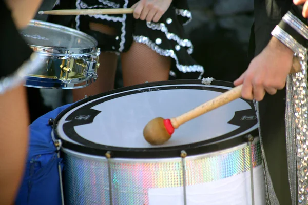 dressed man playing the bass drum profile