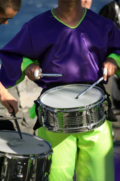 dressed man playing the snare drum face