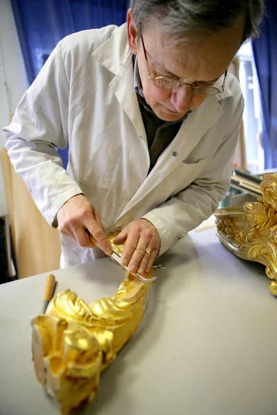 senior man preparing a piece of cake