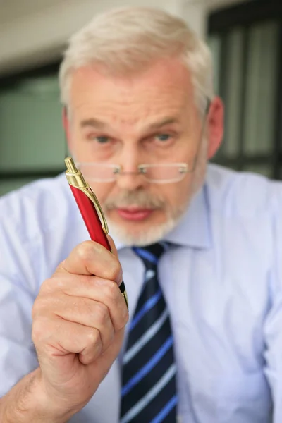 Portrait Senior Man Talking Pen Hand Wearing Eyeglasses — Stock Photo, Image