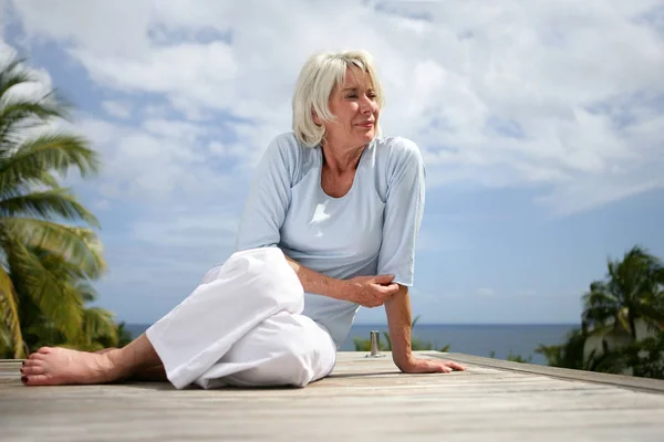 Senior Woman Sitting Floor Looking Away — Stock Photo, Image