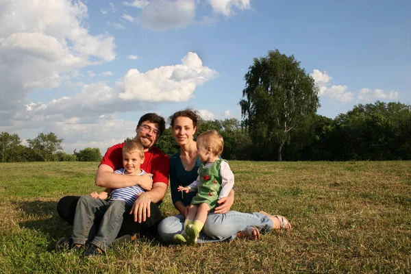 Familia Con Dos Hijos Sentados Prados Árboles — Foto de Stock