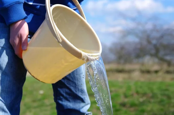 water is poured from a bucket
