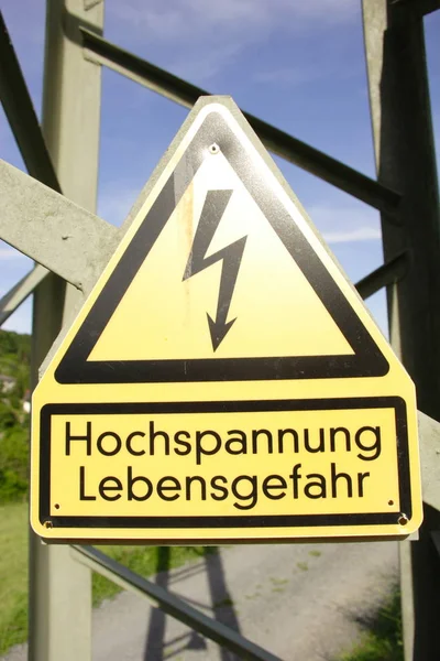 high voltage sign on the road