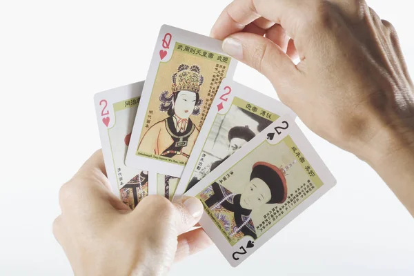 Close-up of a person\'s hands playing cards