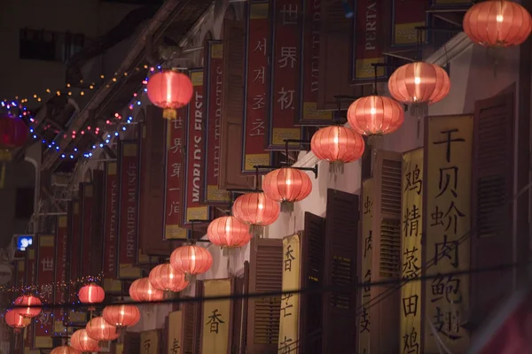 Low angle view of Chinese lanterns on the street lit up at night