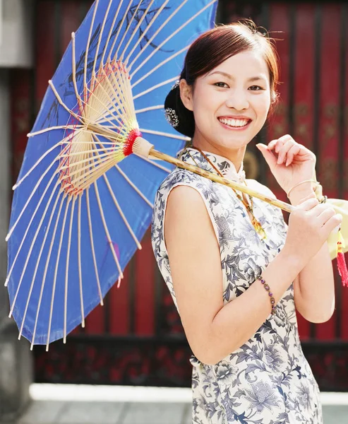 Portrait of a young woman holding a parasol