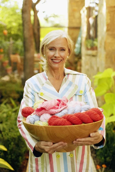 Portrait of a senior woman holding a wicker basket