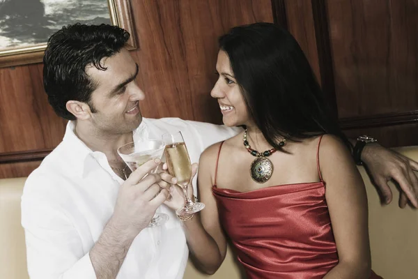 Young couple toasting with champagne flutes and smiling