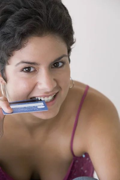 Portrait of young woman with credit card