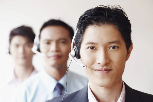 Portrait of three male customer service representatives