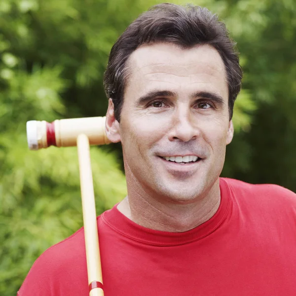 Portrait of a mature man with a croquet mallet