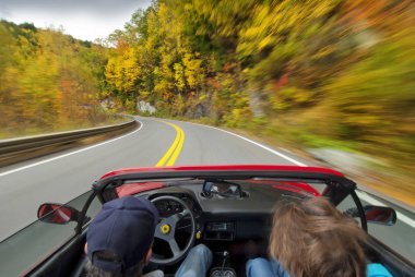 Fall foliage drive in sports car clipart