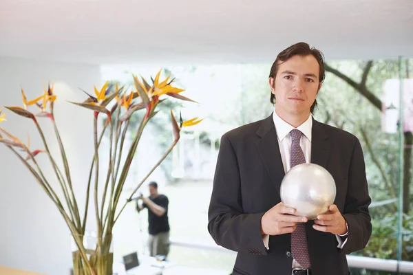 Portrait of a businessman holding a crystal ball