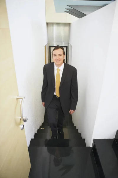 Portrait of a businessman walking up stairs