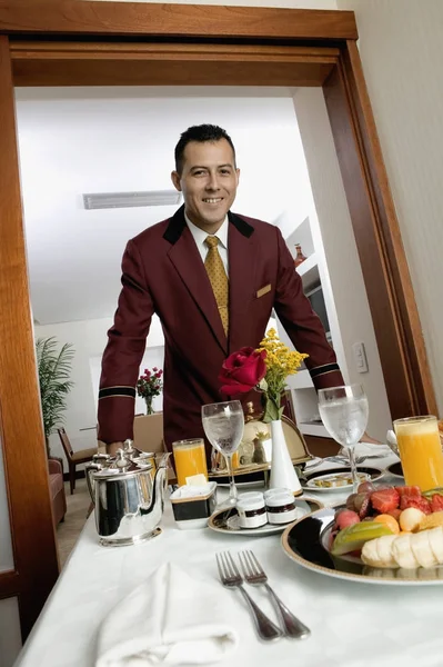 Portrait of a waiter serving food