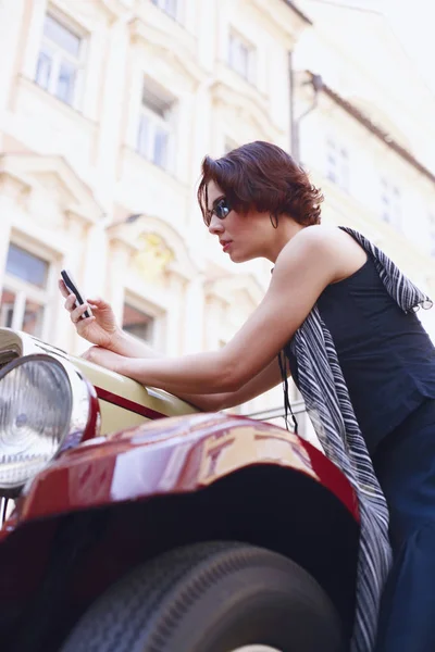 Low angle view of a young woman holding a mobile phone